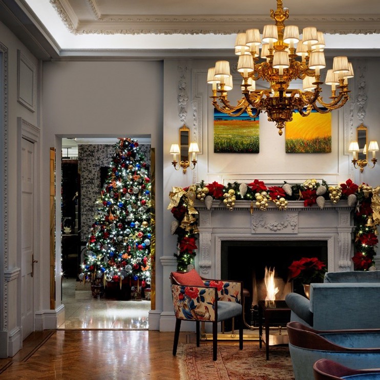 The Stafford London Christmas Decorations - Roaring Fire, Garlands, Christmas Tree adorned with Baubles and Fairy Lights