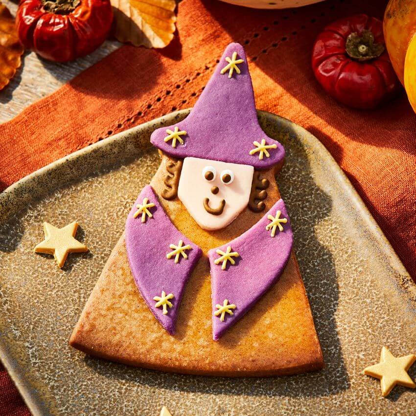 triangular cookie iced to look like a witch