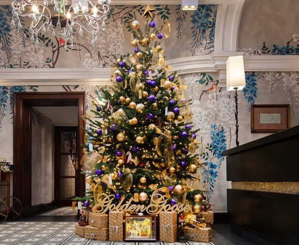 Browns Hotel Interior - Lobby area with Christmas Tree adorned in golden ribbons and bows, with purple baubles and presents